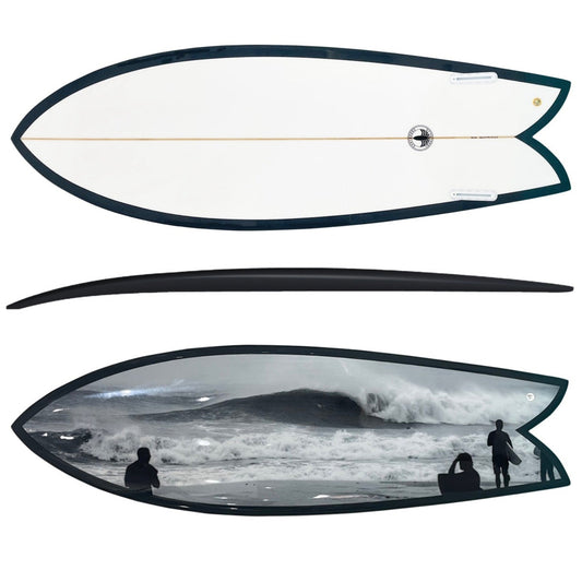 A surfboard shown from two angles on a plain white background: the top view reveals a white deck with a dark outline and center string, and the bottom view shows a black rail with a black-and-white ocean scene printed across the lower half.