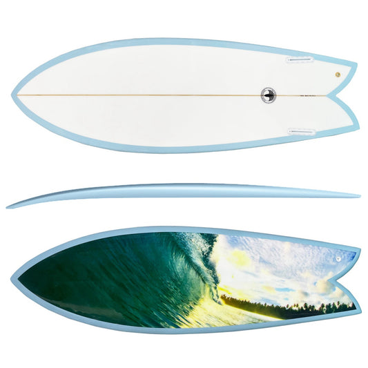 A surfboard shown from two angles on a plain white background: the top view at the top shows a mostly white deck with a light blue outline, and the bottom view at the bottom shows a large wave-and-sky print with blue, green, yellow, and white tones and a light blue outline.